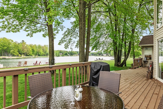 9228 Main St, Canadian Lakes, MI 49346 - wooden terrace with outdoor dining space, a water view, a yard, and a grill