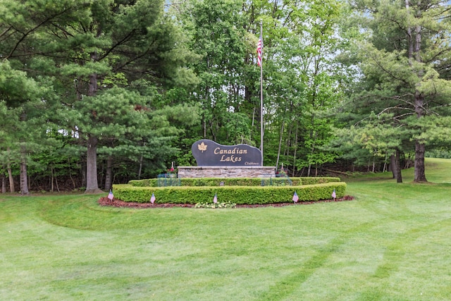 9228 Main St, Canadian Lakes, MI 49346 - community / neighborhood sign with a lawn