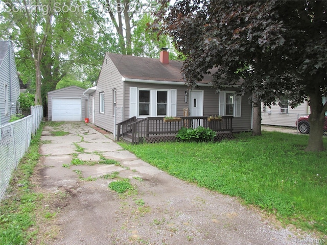 2220 E Bergin Ave, Burton, MI 48529 - view of front of property featuring concrete driveway, an outbuilding, a chimney, a garage, and a deck