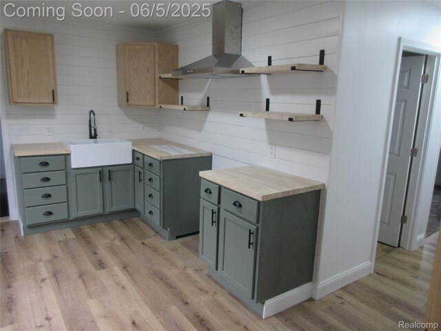 2220 E Bergin Ave, Burton, MI 48529 - kitchen featuring open shelves, a sink, wall chimney exhaust hood, light wood-style floors, and light countertops