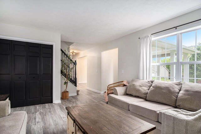 13860 Rolling Creek Dr, Lowell, MI 49331 - living room with stairway, light wood-style flooring, and baseboards