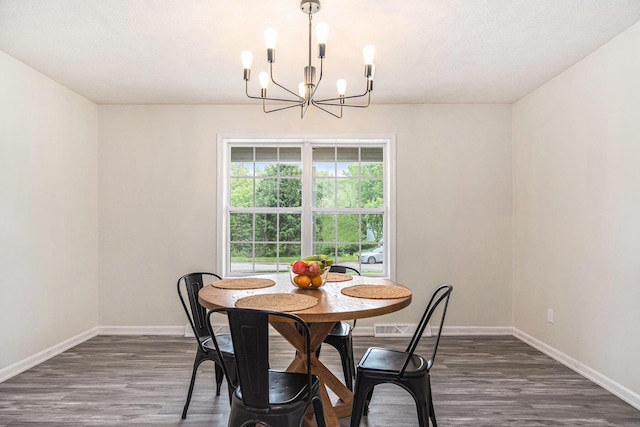 13860 Rolling Creek Dr, Lowell, MI 49331 - dining space featuring a chandelier, baseboards, and dark wood-style flooring