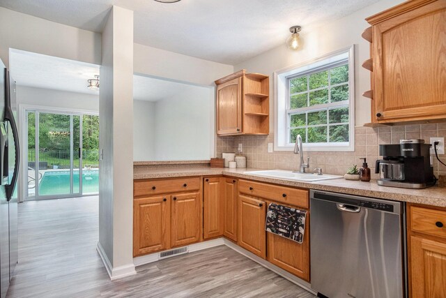 13860 Rolling Creek Dr, Lowell, MI 49331 - kitchen featuring stainless steel appliances, a sink, open shelves, and light countertops
