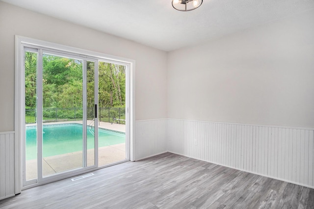 13860 Rolling Creek Dr, Lowell, MI 49331 - empty room featuring wainscoting and wood finished floors