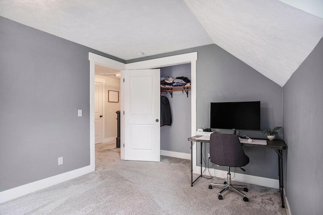 13860 Rolling Creek Dr, Lowell, MI 49331 - carpeted home office with vaulted ceiling, baseboards, and a textured ceiling