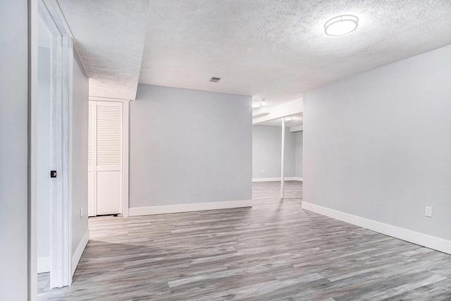 13860 Rolling Creek Dr, Lowell, MI 49331 - unfurnished room featuring wood finished floors, a textured ceiling, and baseboards
