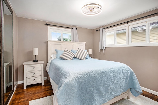 12657 Blue Lagoon Rd, Shelbyville, MI 49344 - bedroom with dark wood-style floors, baseboards, and multiple windows