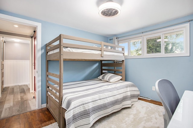 12657 Blue Lagoon Rd, Shelbyville, MI 49344 - bedroom with hardwood / wood-style floors and a wainscoted wall