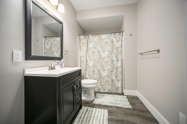 2842 Tall Grass Dr, Grass Lake, MI 49240 - bathroom with vanity, wood finished floors, toilet, and baseboards