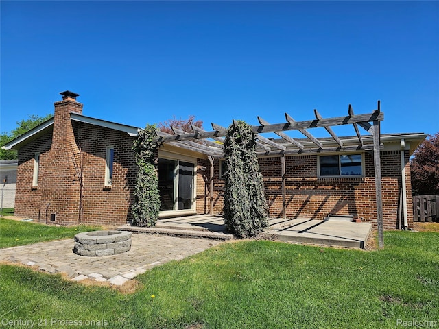 15748 Robert Dr, Macomb, MI 48044 - back of house featuring a patio, a chimney, brick siding, a lawn, and a fire pit