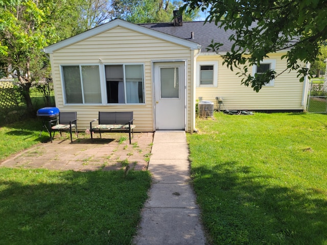 1607 Palmer Ave, Kalamazoo, MI 49001 - rear view of property featuring a patio area, a shingled roof, and central AC