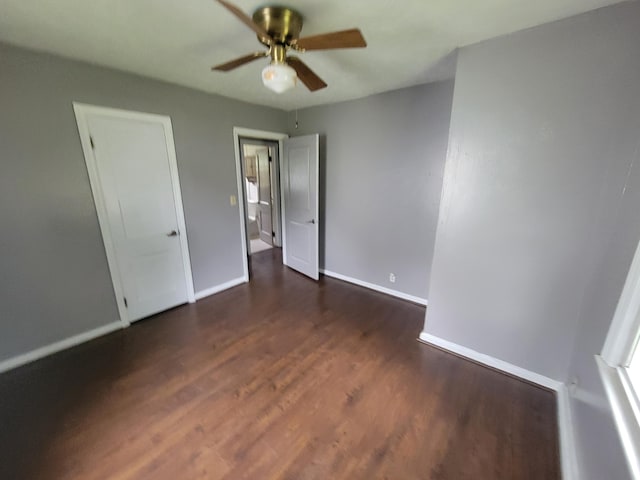 1607 Palmer Ave, Kalamazoo, MI 49001 - unfurnished bedroom featuring dark wood-type flooring, baseboards, and ceiling fan
