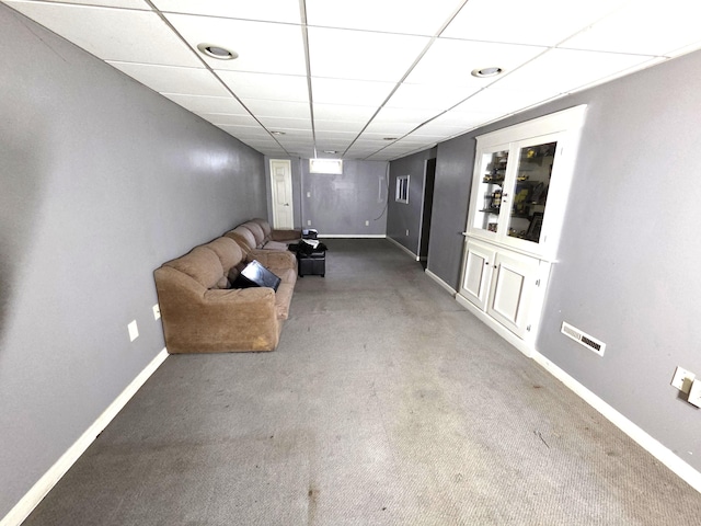 617 Stoll Rd, Lansing, MI 48917 - carpeted living area with baseboards and a paneled ceiling