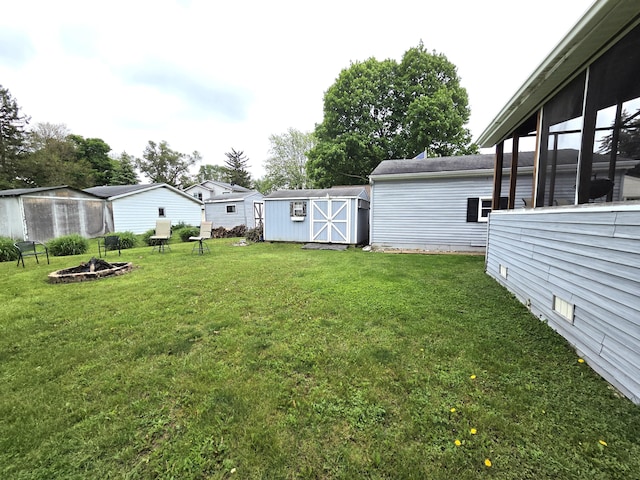 617 Stoll Rd, Lansing, MI 48917 - view of green lawn featuring an outdoor fire pit