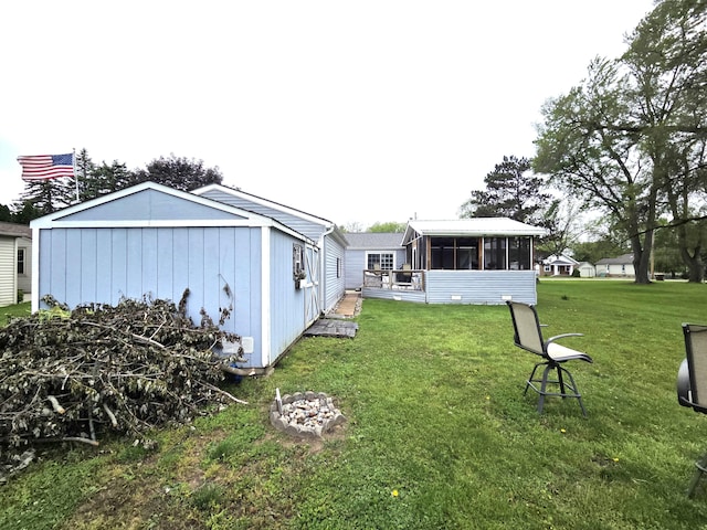 617 Stoll Rd, Lansing, MI 48917 - view of grassy yard featuring a sunroom
