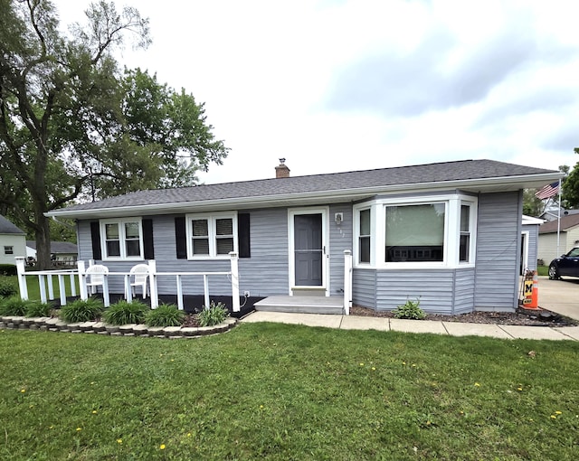 617 Stoll Rd, Lansing, MI 48917 - single story home featuring a front lawn and a chimney