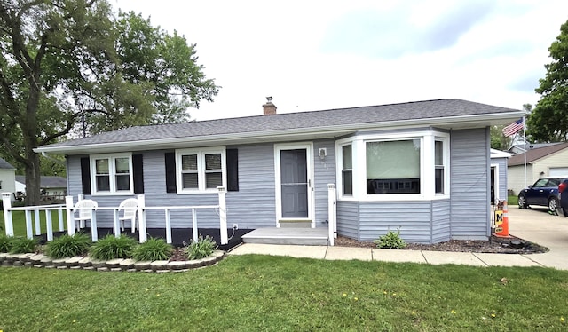 617 Stoll Rd, Lansing, MI 48917 - view of front facade with a front lawn and a chimney