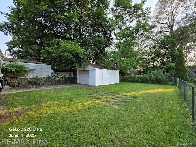 12725 Riverview St, Detroit, MI 48223 - view of yard featuring an outbuilding, a detached garage, and asphalt driveway
