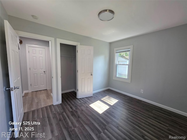 12725 Riverview St, Detroit, MI 48223 - unfurnished bedroom with dark wood-style flooring and a closet