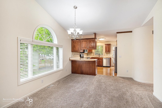 6063 Steeplechase Dr, Grand Blanc, MI 48439 - kitchen featuring stainless steel appliances, a chandelier, a peninsula, vaulted ceiling, and brown cabinetry