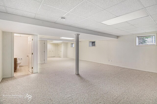 6063 Steeplechase Dr, Grand Blanc, MI 48439 - basement with a paneled ceiling, baseboards, and carpet