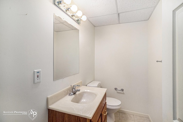 6063 Steeplechase Dr, Grand Blanc, MI 48439 - bathroom featuring a paneled ceiling, vanity, toilet, tile patterned flooring, and baseboards