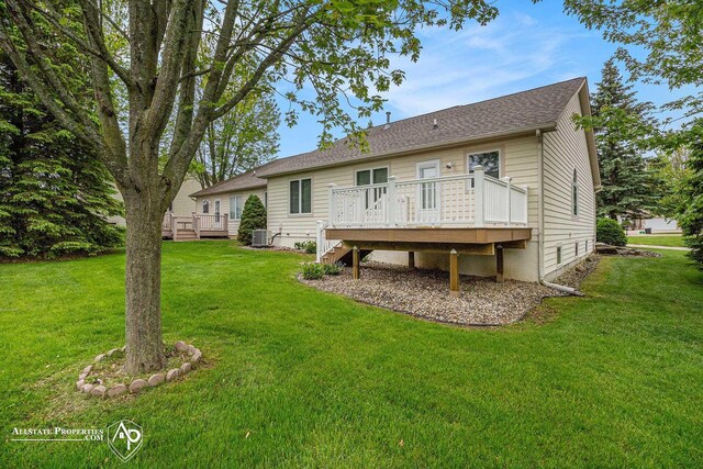 6063 Steeplechase Dr, Grand Blanc, MI 48439 - back of house featuring a wooden deck, a lawn, cooling unit, and roof with shingles