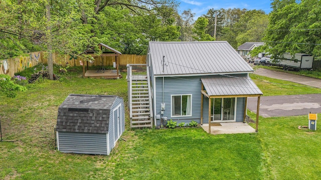 418 W Fargo St, Ionia, MI 48846 - rear view of property featuring a wooden deck and metal roof