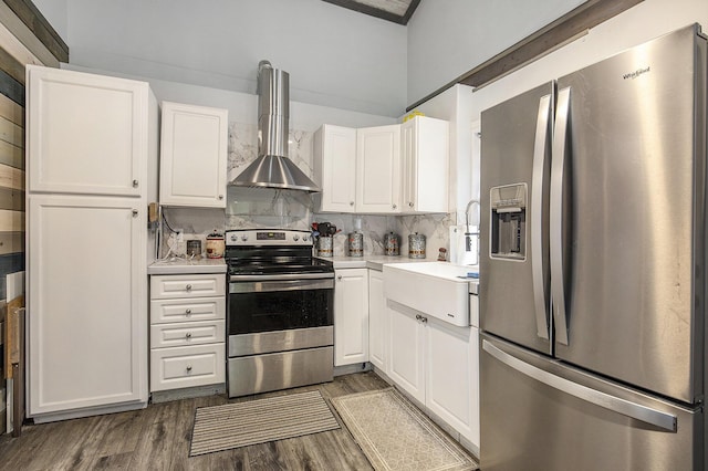 418 W Fargo St, Ionia, MI 48846 - kitchen with stainless steel appliances, wall chimney exhaust hood, white cabinets, and light countertops