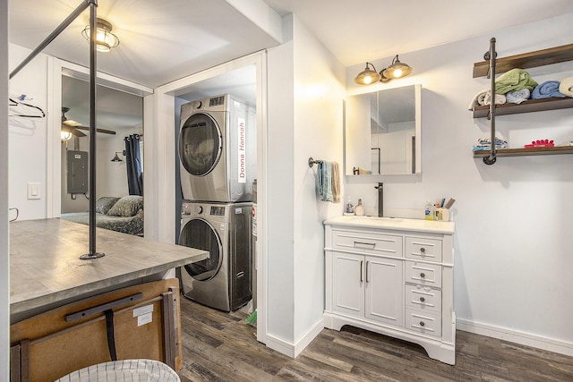 418 W Fargo St, Ionia, MI 48846 - washroom featuring stacked washer / dryer, dark wood-style flooring, baseboards, and electric panel