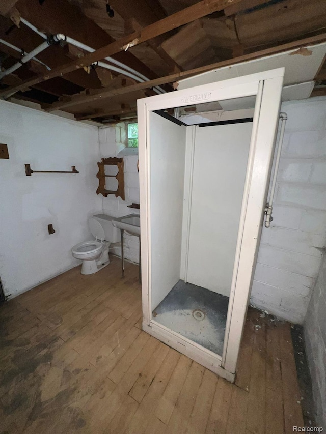 20258 Fairport St, Detroit, MI 48205 - bathroom with hardwood / wood-style flooring, toilet, and a shower stall
