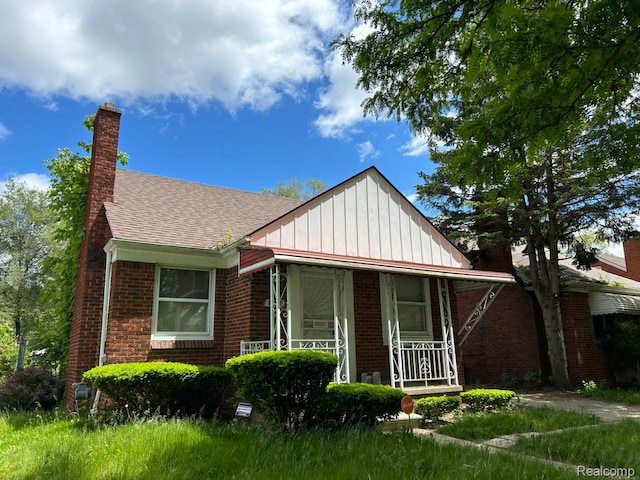 20258 Fairport St, Detroit, MI 48205 - bungalow-style house featuring covered porch, board and batten siding, brick siding, and a shingled roof