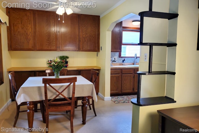 917 N Edison Ave, Royal Oak, MI 48067 - dining space with a ceiling fan, light floors, arched walkways, baseboards, and crown molding