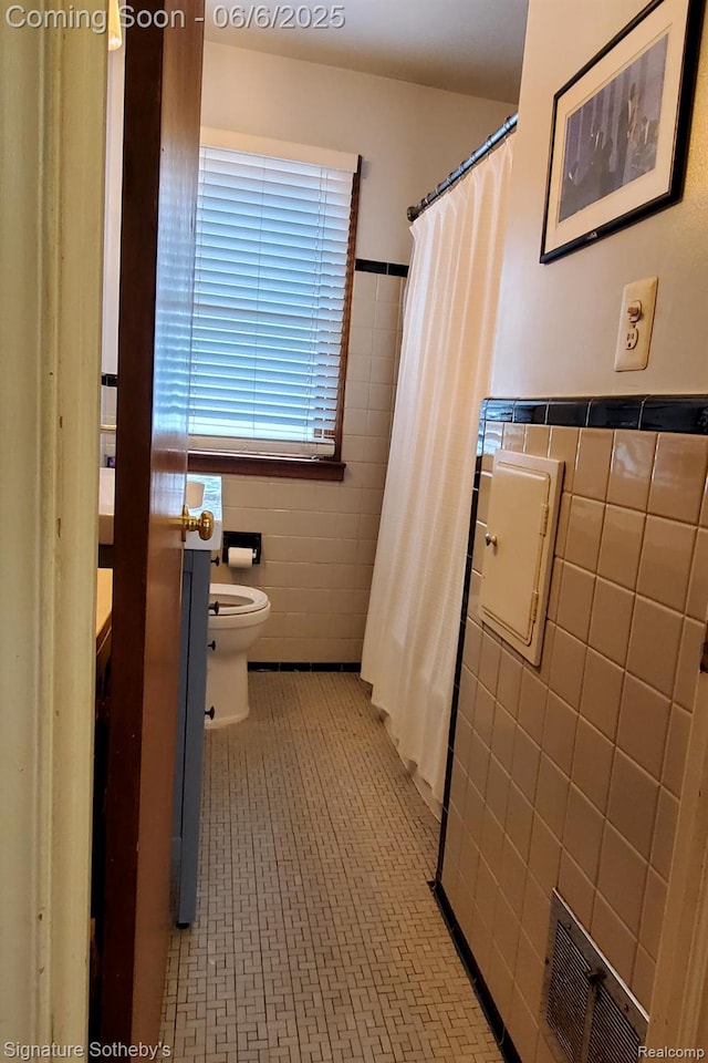 917 N Edison Ave, Royal Oak, MI 48067 - bathroom featuring tile walls, toilet, curtained shower, and wainscoting