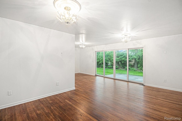 429 Bella Vis, Grand Blanc, MI 48439 - spare room with a chandelier, wood finished floors, and baseboards