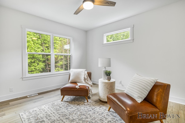 4846 Honeycrisp Dr NE, Rockford, MI 49341 - living area featuring a ceiling fan, baseboards, and wood finished floors