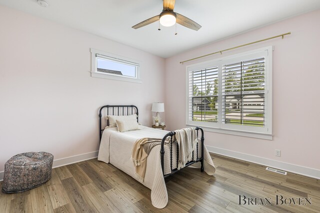 4846 Honeycrisp Dr NE, Rockford, MI 49341 - bedroom with baseboards, wood finished floors, and ceiling fan