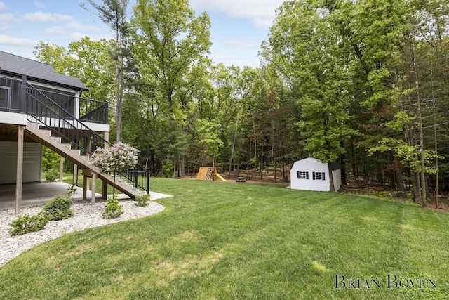4846 Honeycrisp Dr NE, Rockford, MI 49341 - view of grassy yard with stairs, a playground, a deck, and a patio area