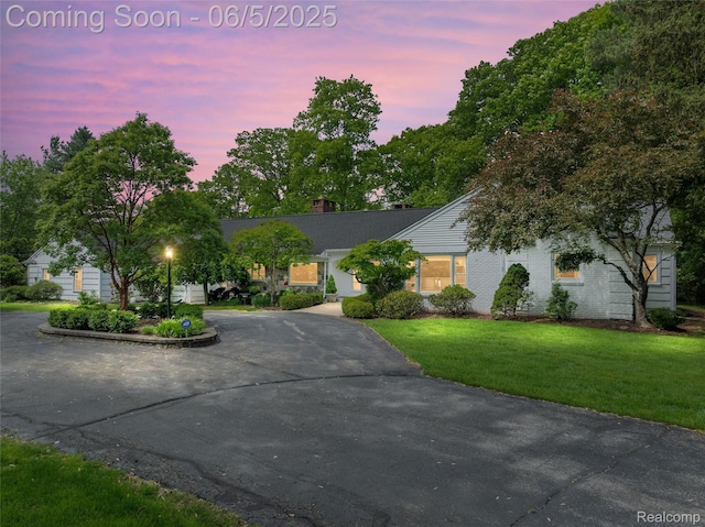 22191 Camelot Ct, Beverly Hills, MI 48025 - view of front of home with a lawn, curved driveway, and a chimney