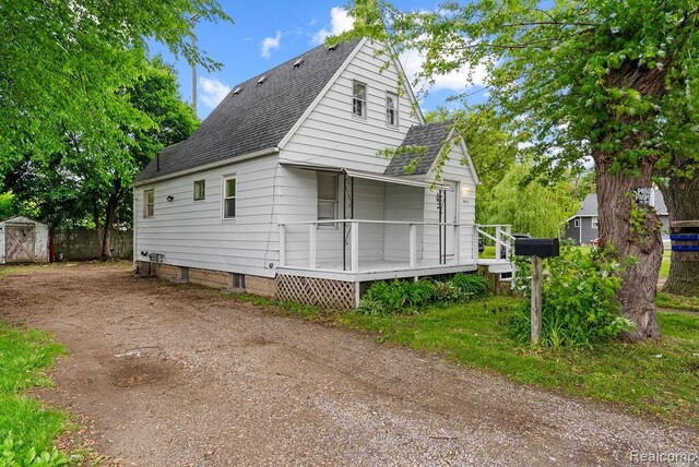 3401 Davison Rd, Flint, MI 48506 - view of front of house with roof with shingles and a wooden deck