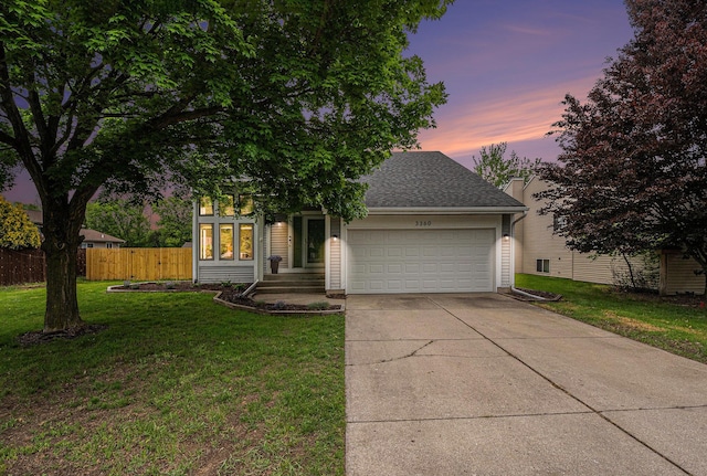 3360 Brook Trl SE, Grand Rapids, MI 49508 - view of property hidden behind natural elements featuring a garage, concrete driveway, and a shingled roof