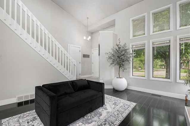3360 Brook Trl SE, Grand Rapids, MI 49508 - living area with stairs, a towering ceiling, baseboards, a chandelier, and dark wood finished floors