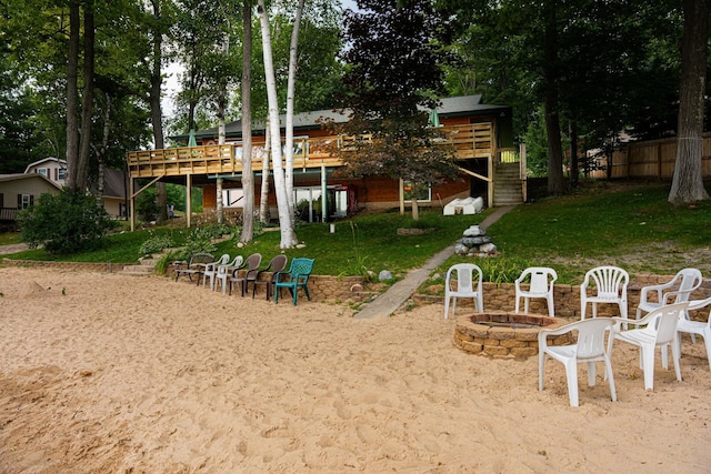 376 Highview Rd, Traverse City, MI 49696 - view of play area with a fire pit, stairway, and a deck