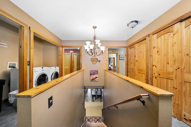 376 Highview Rd, Traverse City, MI 49696 - stairway featuring a chandelier and washing machine and clothes dryer