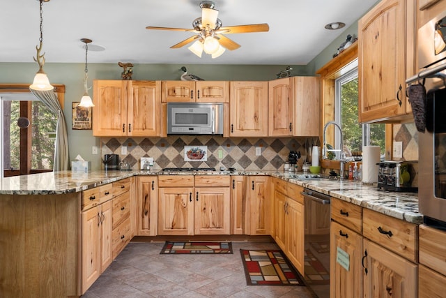 376 Highview Rd, Traverse City, MI 49696 - kitchen featuring stainless steel dishwasher, a sink, a peninsula, decorative backsplash, and gas cooktop