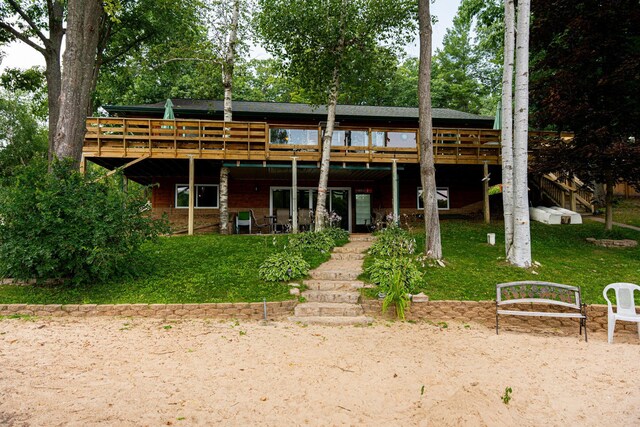 376 Highview Rd, Traverse City, MI 49696 - back of house featuring stairway, a wooden deck, and a yard
