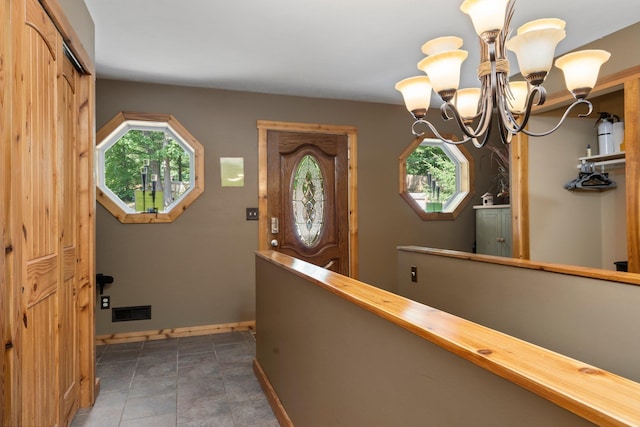 376 Highview Rd, Traverse City, MI 49696 - foyer with baseboards and a chandelier
