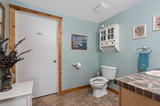 376 Highview Rd, Traverse City, MI 49696 - bathroom featuring baseboards, vanity, and toilet
