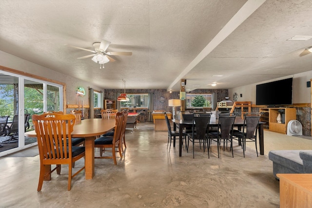 376 Highview Rd, Traverse City, MI 49696 - dining space featuring a ceiling fan, concrete flooring, and a textured ceiling
