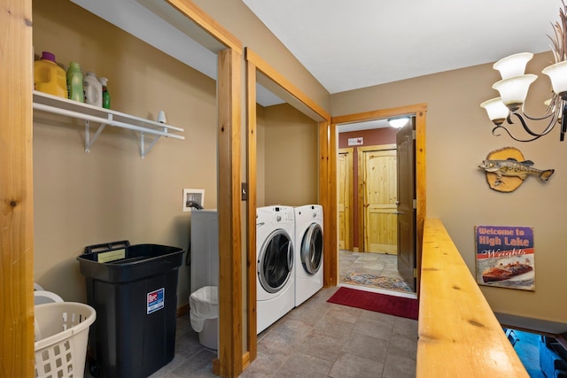 376 Highview Rd, Traverse City, MI 49696 - laundry room with washing machine and clothes dryer and stone finish flooring